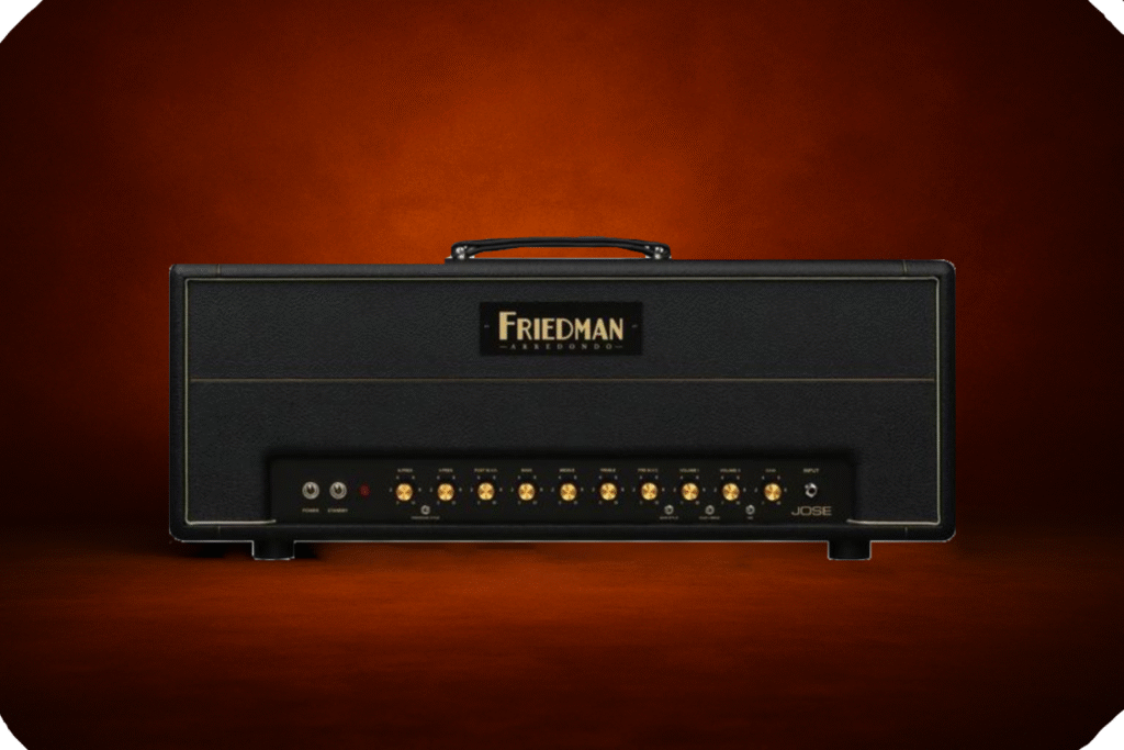Friedman Arredondo Jose guitar amplifier head displayed against a dark orange studio backdrop, showcasing its black and gold front panel with labeled knobs and toggle switches.