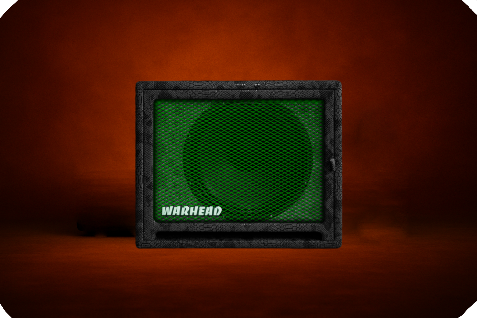 Warhead guitar speaker cabinet with green metal grille, black textured enclosure, Warhead logo, and compact form factor, studio-lit against a dark orange background.